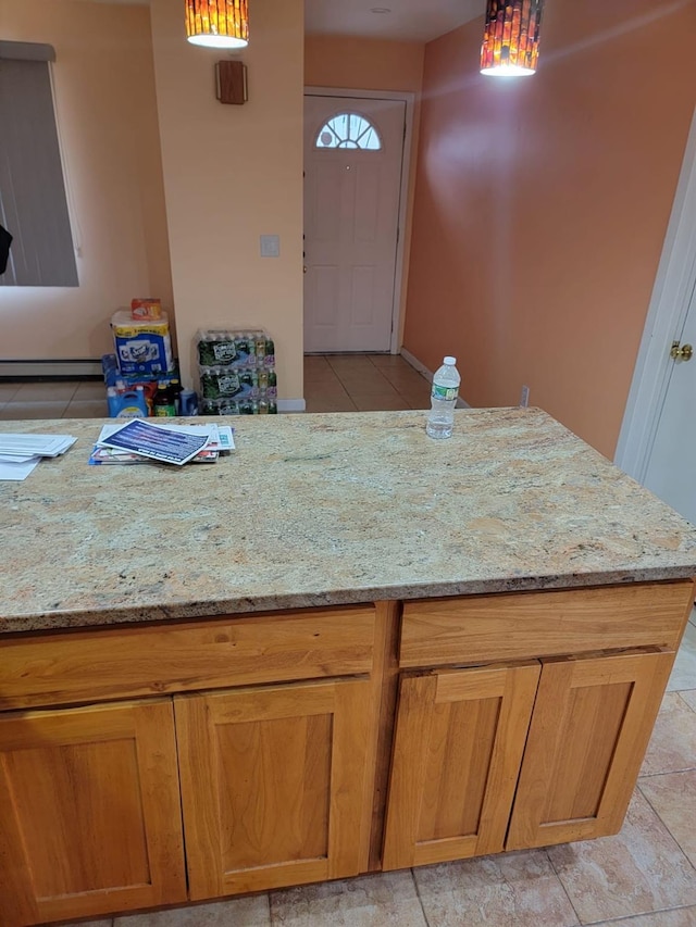 kitchen with light stone counters and light tile patterned floors