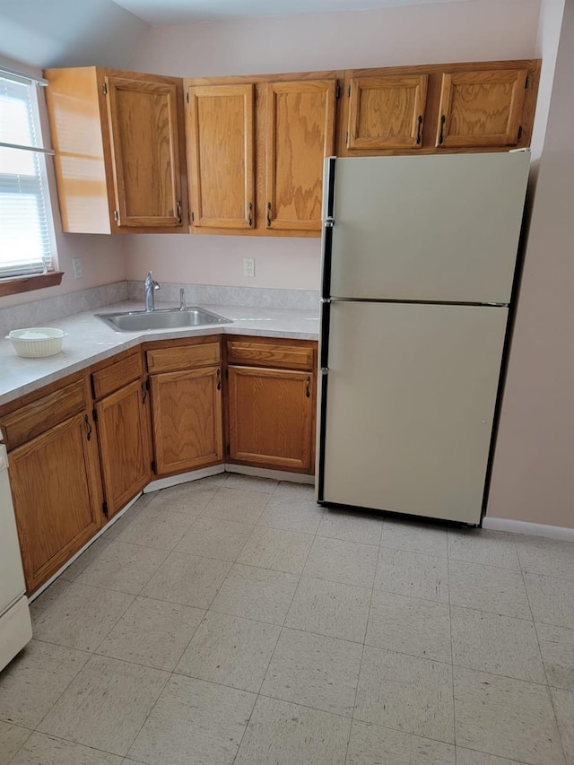 kitchen with sink and white fridge