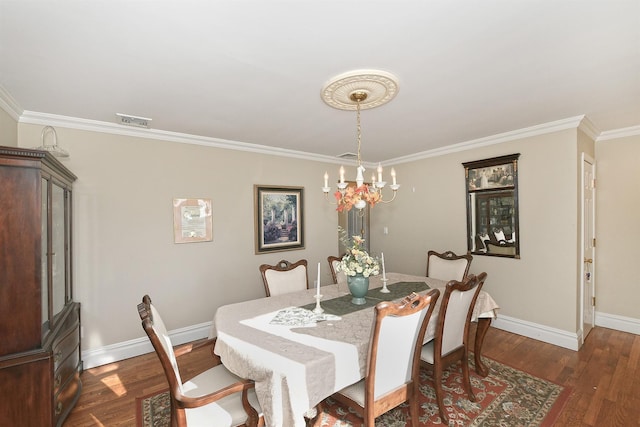 dining room featuring crown molding, dark hardwood / wood-style flooring, and an inviting chandelier