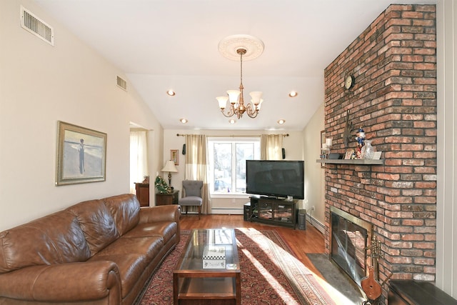 living room with dark wood-type flooring, a baseboard radiator, vaulted ceiling, and a brick fireplace