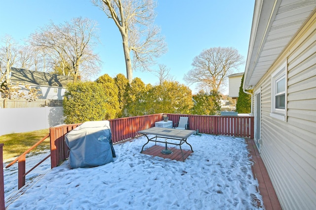 yard layered in snow featuring a wooden deck