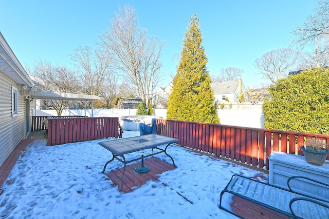 snow covered deck featuring a hot tub