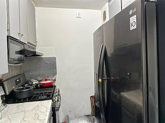 153-25 88th St Unit 5H, Howard Beach, NY 11414 - kitchen featuring black appliances, white cabinetry, light stone countertops, and under cabinet range hood