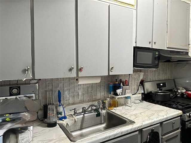 153-25 88th St Unit 5H, Howard Beach, NY 11414 - kitchen featuring gas stove, black microwave, light countertops, white cabinets, and under cabinet range hood