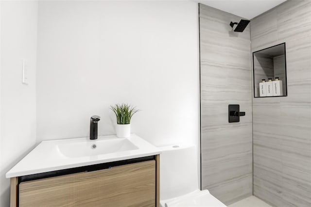 bathroom featuring a shower and vanity