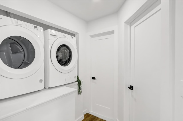 laundry area featuring laundry area, washing machine and dryer, and wood finished floors