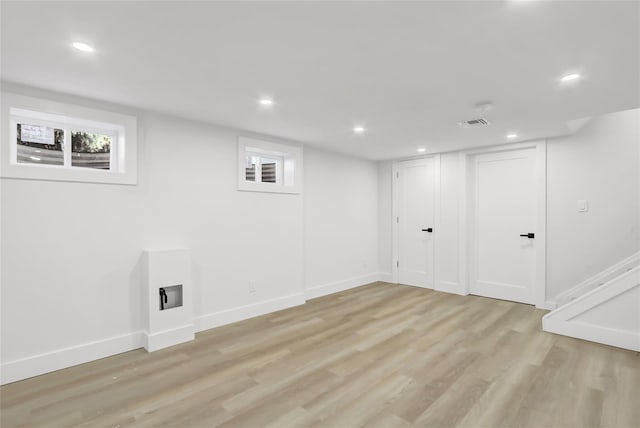 basement featuring light wood finished floors, recessed lighting, and baseboards