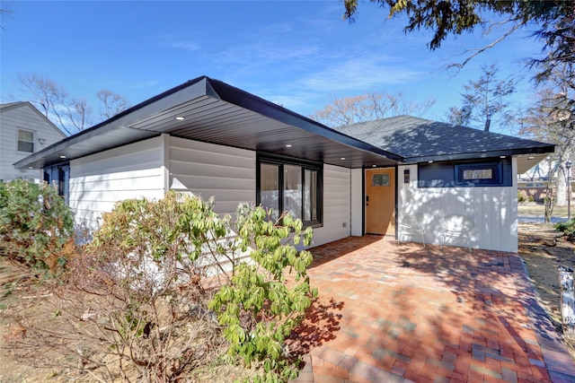 view of front of property with roof with shingles