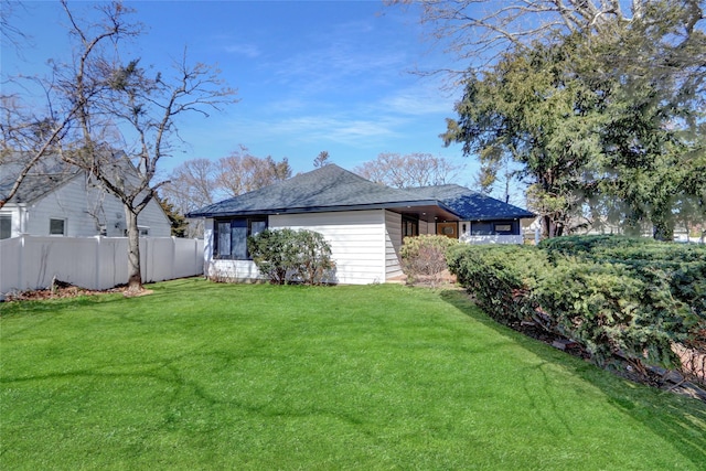 exterior space with a front yard and fence