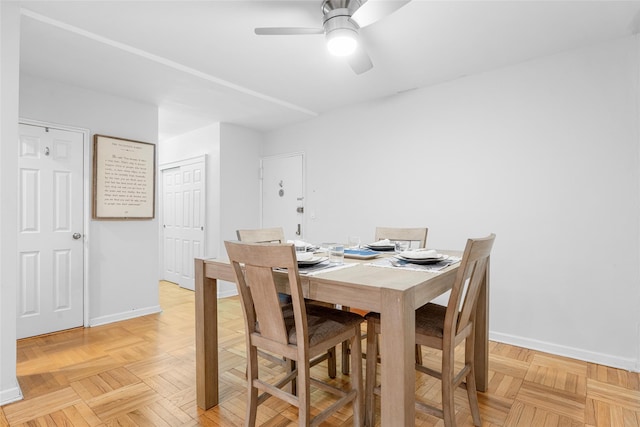 dining space featuring light parquet flooring and ceiling fan