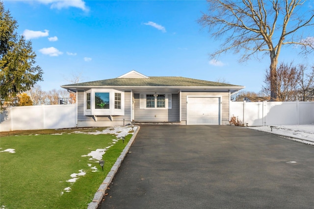 ranch-style home with a garage and a front yard