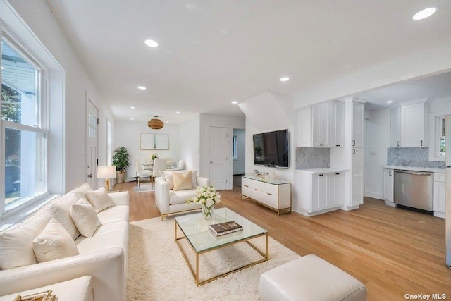 living room featuring a wealth of natural light and light wood-type flooring