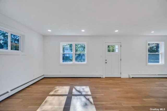 interior space featuring a baseboard radiator and light hardwood / wood-style floors