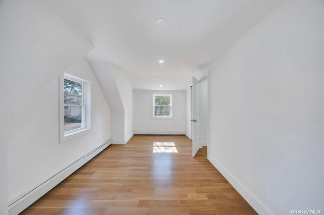 interior space featuring a baseboard radiator and light hardwood / wood-style flooring