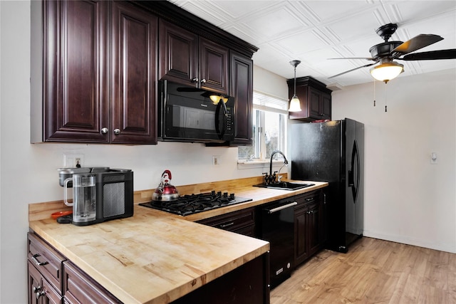 4 Young Rd, Coram, NY 11727 - kitchen featuring a sink, ceiling fan, black appliances, butcher block counters, and light wood finished floors