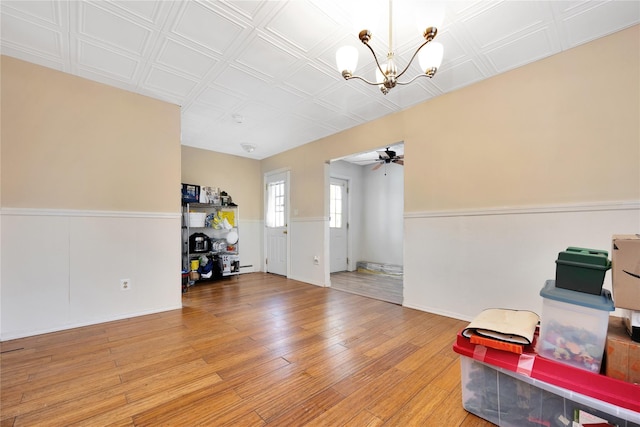 4 Young Rd, Coram, NY 11727 - interior space with a wainscoted wall, ceiling fan with notable chandelier, and light wood-style flooring