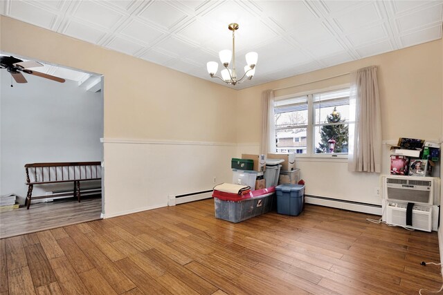 4 Young Rd, Coram, NY 11727 - rec room with a baseboard radiator, wood finished floors, and ceiling fan with notable chandelier