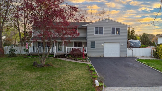 4 Young Rd, Coram, NY 11727 - traditional home with a porch, a front lawn, a garage, aphalt driveway, and fence