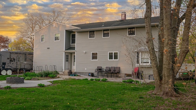 4 Young Rd, Coram, NY 11727 - back of house with a fire pit, a chimney, a yard, and a patio