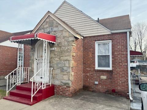 view of front of house with stone siding and brick siding