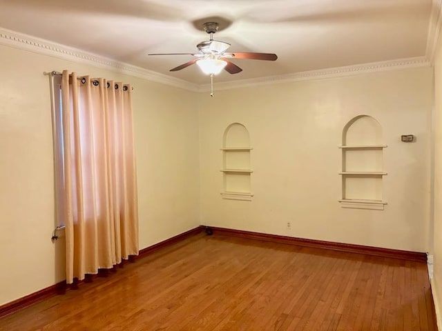 221-14 114th Rd, Cambria Heights, NY 11411 - unfurnished room featuring baseboards, hardwood / wood-style floors, built in features, and crown molding