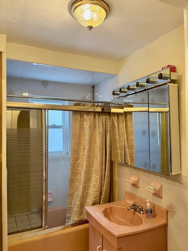 221-14 114th Rd, Cambria Heights, NY 11411 - bathroom with shower / bathtub combination with curtain and vanity