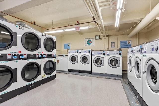 washroom with stacked washer and clothes dryer and washing machine and dryer