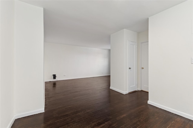 empty room with dark hardwood / wood-style flooring