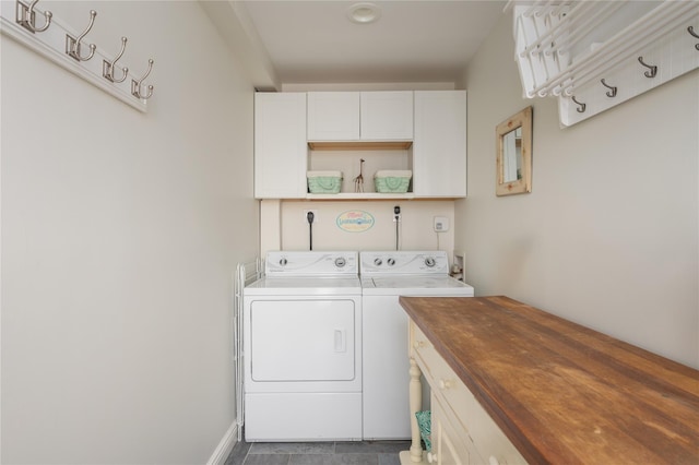 washroom with cabinet space and washer and dryer