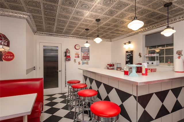 interior space featuring a dry bar, an ornate ceiling, and tile patterned floors