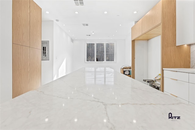 104 Stockton Unit 6, Brooklyn, NY 11206 - kitchen featuring light stone countertops, modern cabinets, visible vents, and recessed lighting