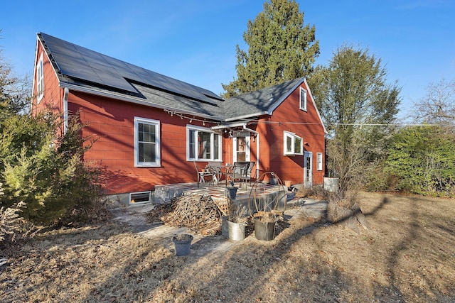 view of front facade featuring roof mounted solar panels