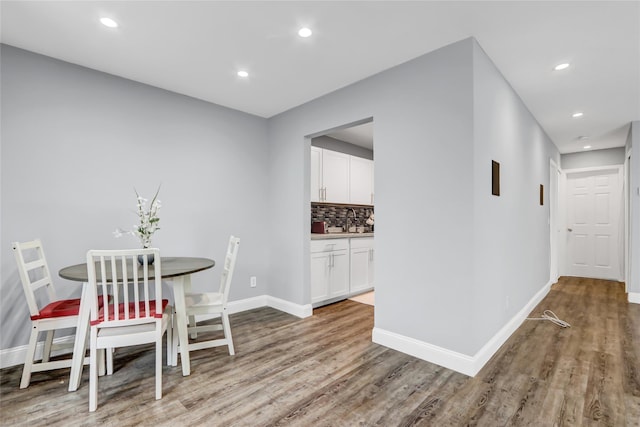 dining area featuring sink and light hardwood / wood-style flooring