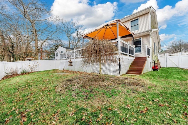 rear view of property with a lawn