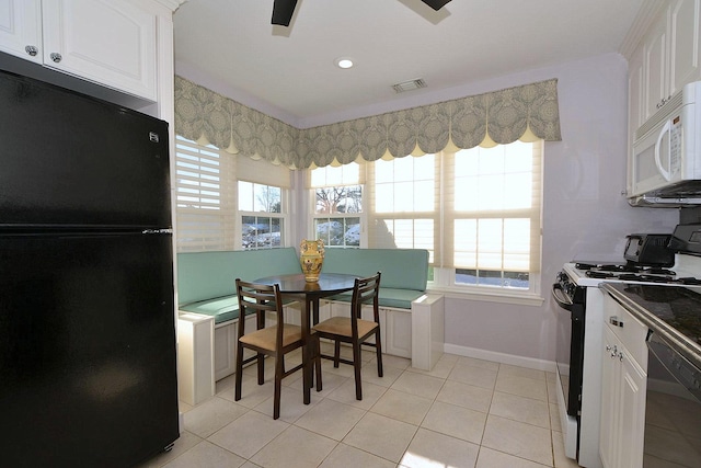 kitchen featuring white cabinetry, light tile patterned floors, black appliances, and ceiling fan