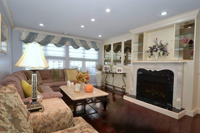 living room with a high end fireplace, ornamental molding, and wood-type flooring