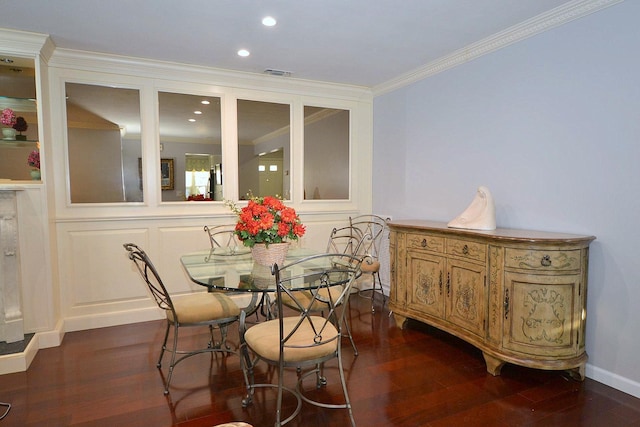 dining room featuring crown molding and dark wood-type flooring