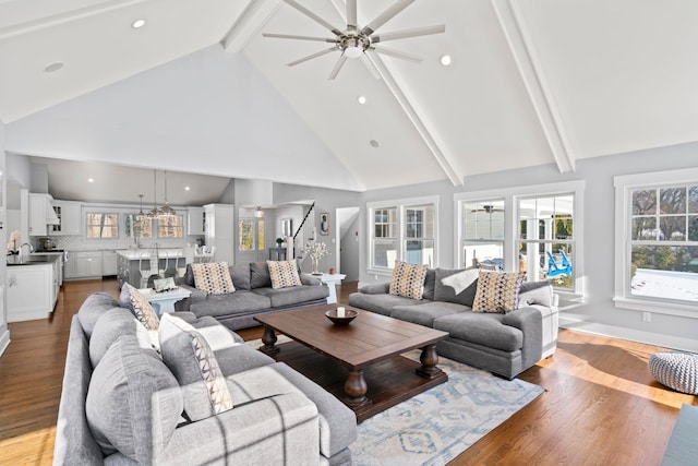 living room with beam ceiling, high vaulted ceiling, light hardwood / wood-style flooring, and a wealth of natural light