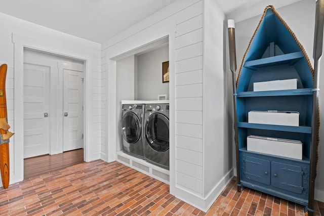 clothes washing area with independent washer and dryer