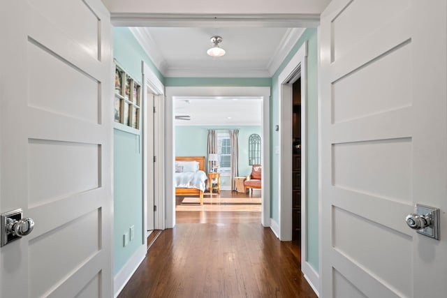 corridor with ornamental molding and dark hardwood / wood-style flooring