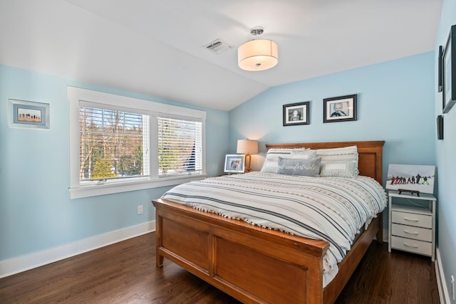 bedroom with dark wood-type flooring and vaulted ceiling