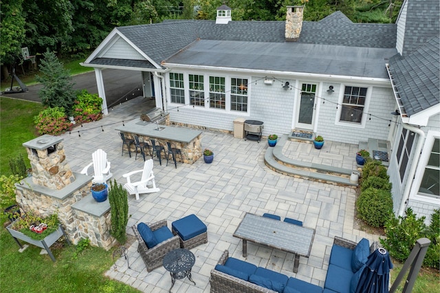 rear view of house with a patio and a bar