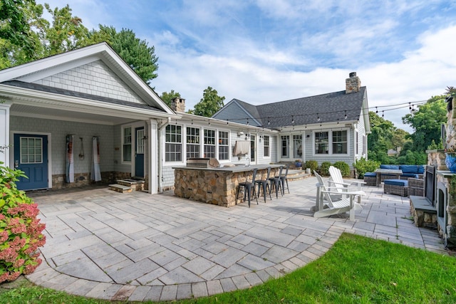 view of patio / terrace featuring a bar and an outdoor hangout area