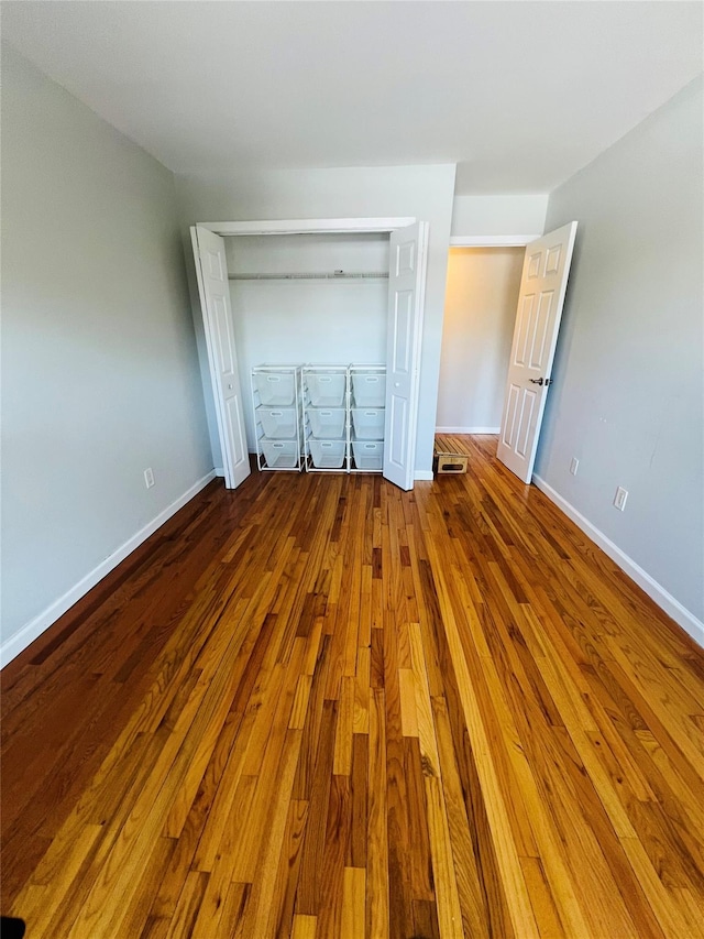 17 Broadway Unit 1K, Harrison, NY 10528 - unfurnished bedroom with hardwood / wood-style flooring and a closet