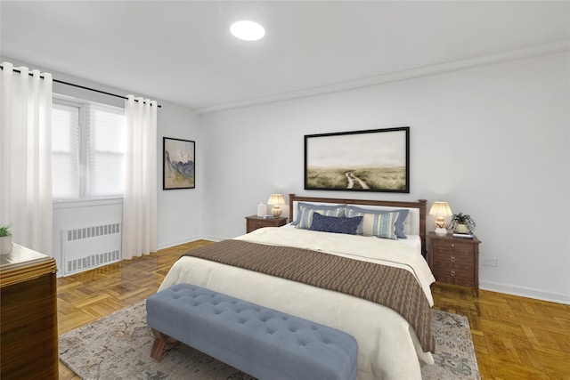 bedroom featuring parquet floors and radiator heating unit