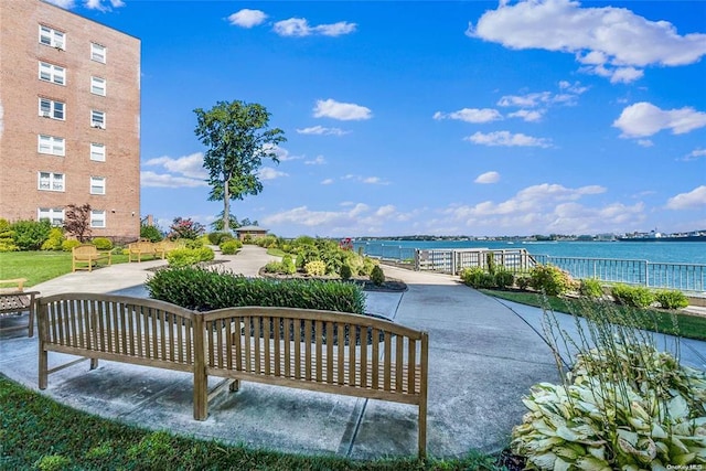 view of community featuring a water view and a patio area