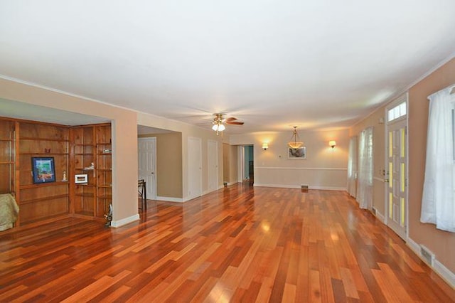 unfurnished living room with hardwood / wood-style flooring and ceiling fan