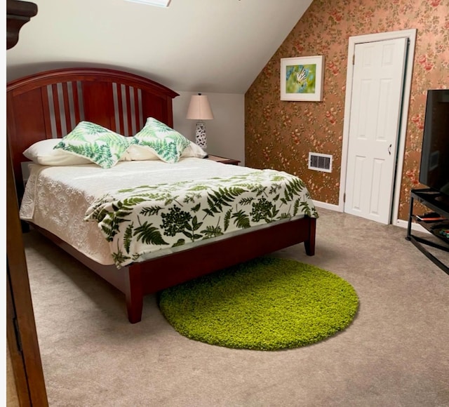 bedroom featuring vaulted ceiling and carpet