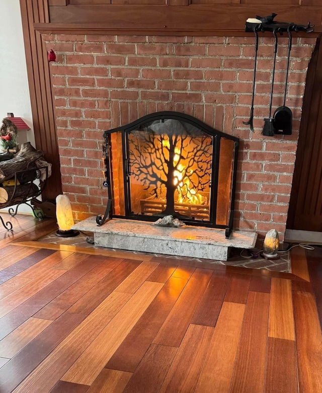 room details with a brick fireplace and wood finished floors