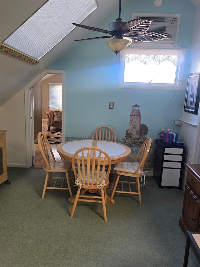 dining room with carpet floors, ceiling fan, plenty of natural light, and vaulted ceiling